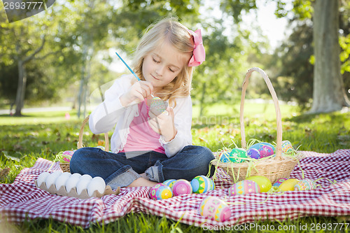 Image of Cute Young Girl Coloring Her Easter Eggs with Paint Brush