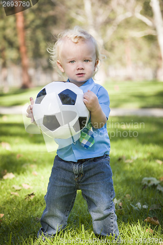 Image of Young Cute Boy Playing with Soccer Ball in Park