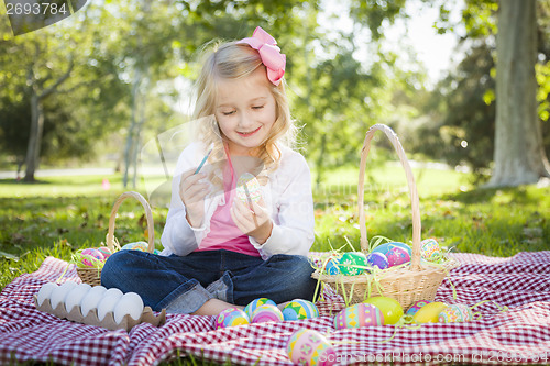 Image of Cute Young Girl Coloring Her Easter Eggs with Paint Brush