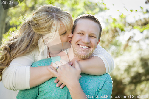 Image of Young Attractive Couple Hugging in the Park