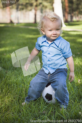 Image of Young Cute Boy Playing with Soccer Ball in Park