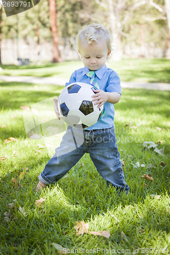 Image of Young Cute Boy Playing with Soccer Ball in Park