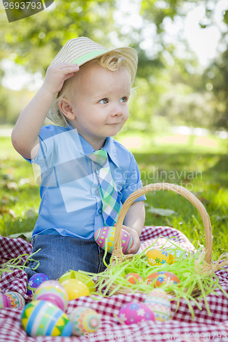 Image of Cute Little Boy Outside Holding Easter Eggs Tips His Hat