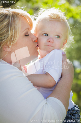 Image of Young Mother Kissing and Holding Her Adorable Baby Boy