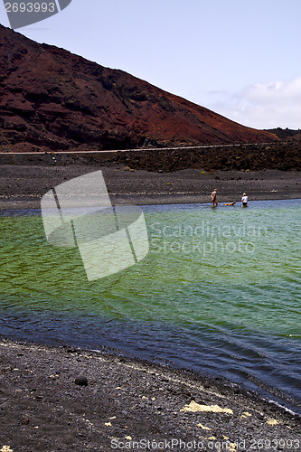 Image of street people dog stone  atlantic ocean sky  water     and summe