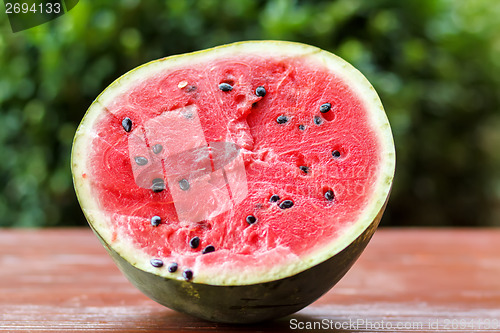 Image of Fresh juicy watermelon against natural green background