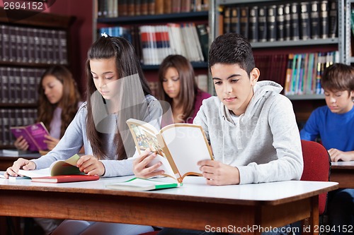 Image of Male And Female Friend Studying In Library