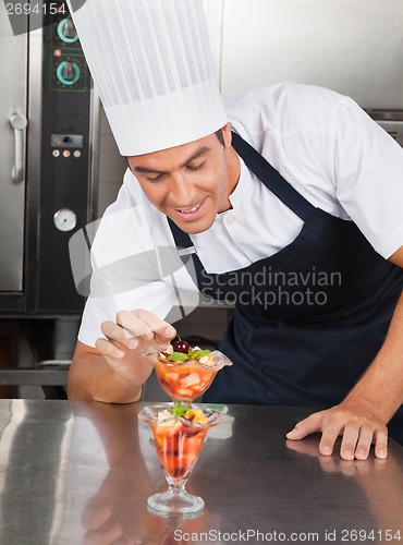 Image of Young Chef Decorating Delicious Dessert