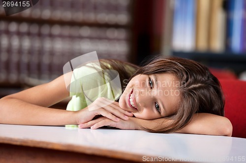 Image of Thoughtful Schoolgirl Leaning On Table In Library