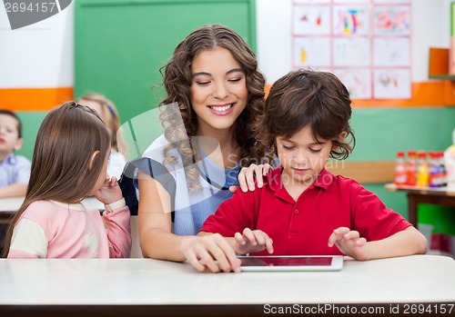 Image of Boy With Teacher Using Digital Tablet