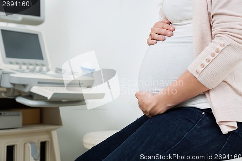 Image of Pregnant Woman By Ultrasound Machine In Clinic