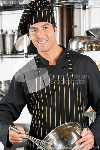 Image of Young Chef Holding Wire Whisk And Mixing Bowl