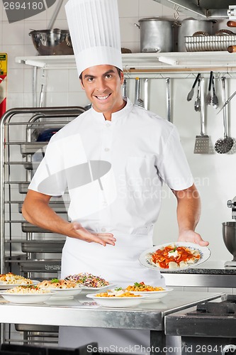 Image of Male Chef Presenting Pasta Dish