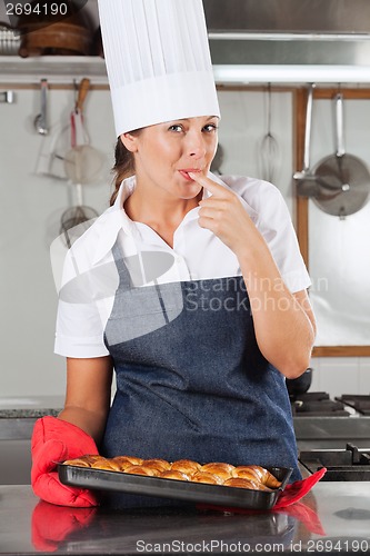 Image of Female Chef Licking Finger