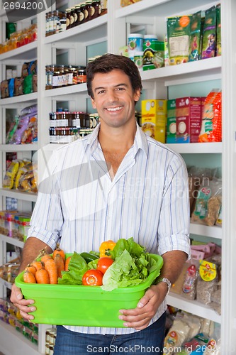 Image of Man With Vegetable Basket In Supermarket