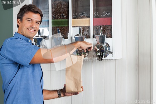 Image of Man Buying Coffee Beans At Grocery Store