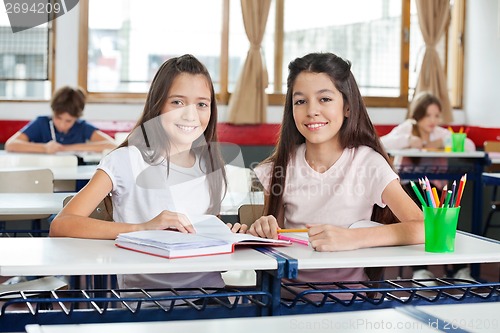 Image of Portrait Of Happy Schoolgirls Sitting