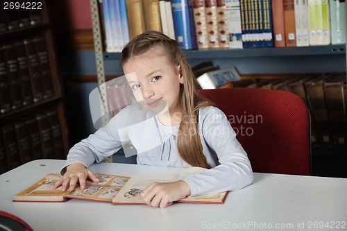 Image of Little Girl Sitting At Table With Books