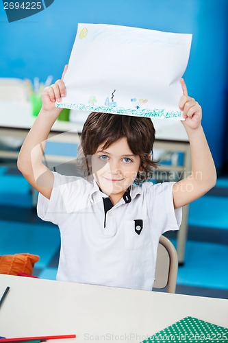 Image of Boy Showing Drawing Paper In Classroom