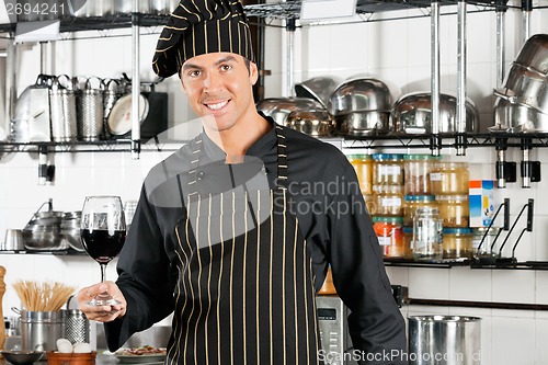 Image of Chef Holding Glass Of Red Wine