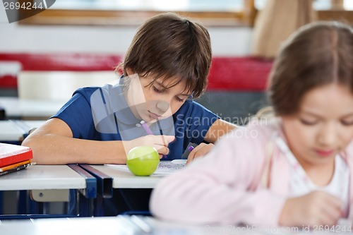 Image of Schoolboy Drawing In Classroom