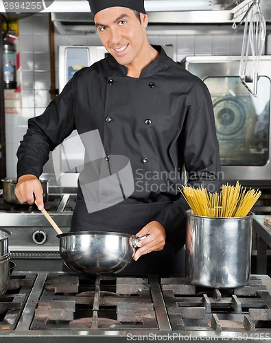 Image of Happy Chef Preparing Pasta