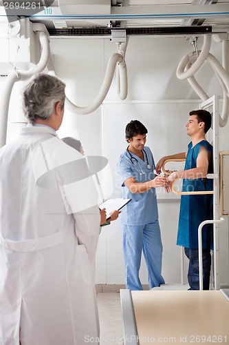 Image of Medical Team With Patient In X-ray Room