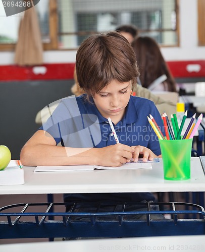 Image of Little Schoolboy Studying At Desk