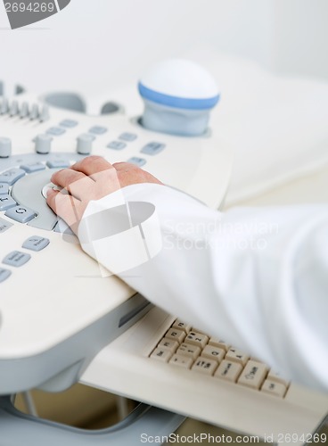 Image of Doctor's Hand Using Ultrasound Machine