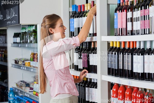 Image of Young Woman Shopping For Alcohol