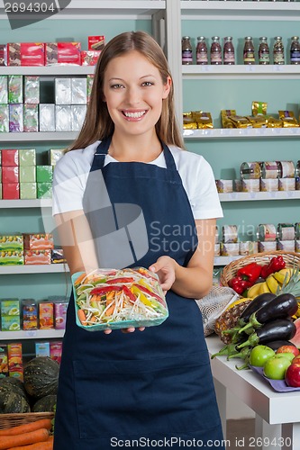 Image of Saleswoman Holding Vegetable