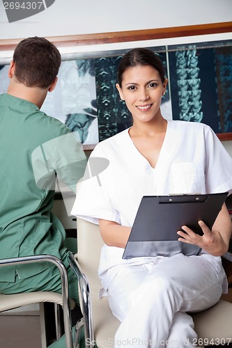 Image of Female Medical Technician Holding Clipboard