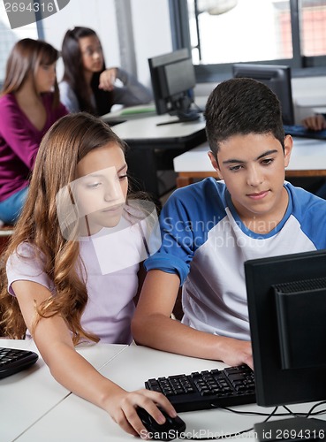 Image of Schoolchildren Using Computer At Desk