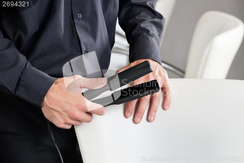 Image of Hairstylist Holding Straightener