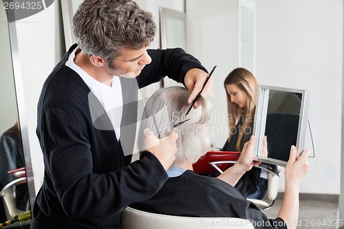 Image of Hairdresser Cutting Client's Hair At Salon