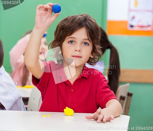 Image of Boy Showing Clay In Classroom