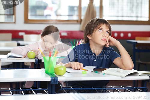 Image of Young Boy Looking Up In Classroom