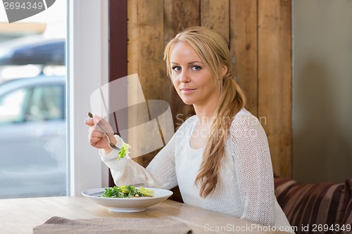 Image of Pretty Woman With Plate Of Salad In Cafe