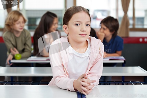 Image of Little Schoolgirl Leaning At Desk