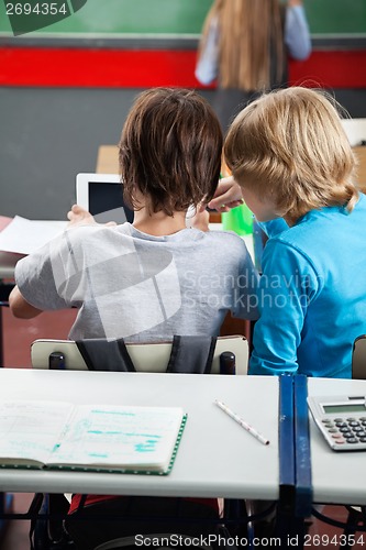 Image of Schoolboys Using Digital Tablet At Desk