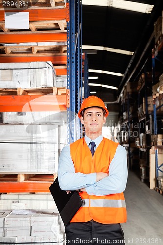 Image of Male Supervisor With Arms Crossed At Warehouse