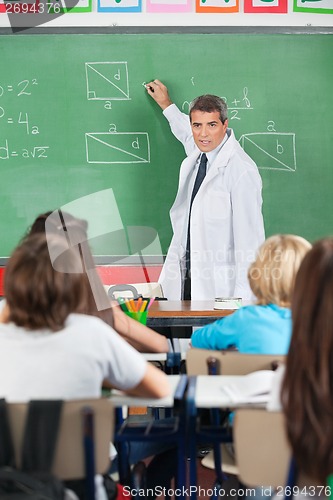 Image of Teacher Teaching While Writing On Board