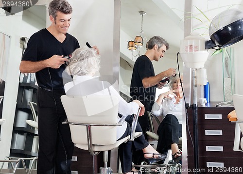 Image of Hairdresser Styling Woman's Hair