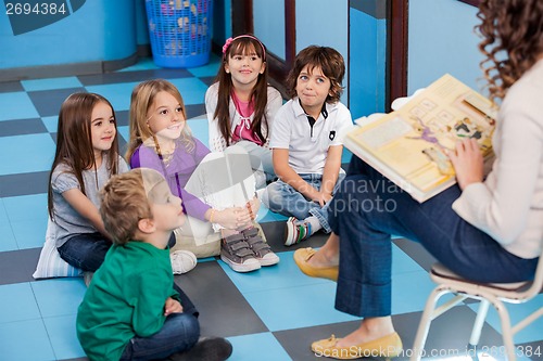 Image of Teacher Reading Story Book To Children