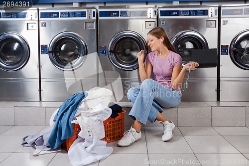 Image of Woman Enjoying Music In Laundry