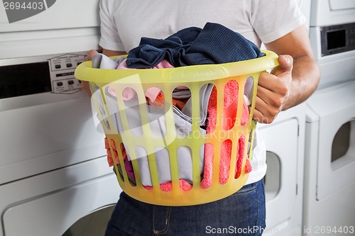 Image of Man Carrying Laundry Basket