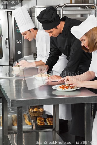 Image of Chefs Garnishing Pasta Dishes