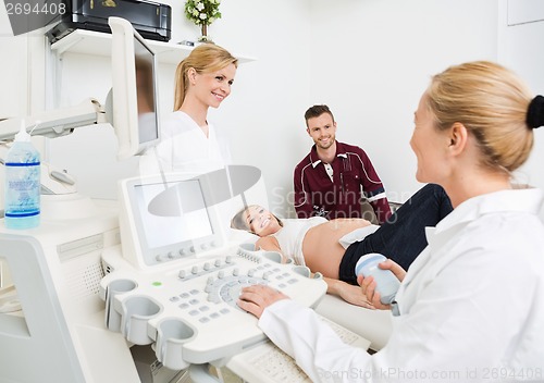 Image of Gynecologists And Expectant Couple In Clinic