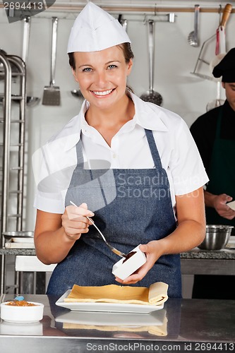 Image of Happy Chef Preparing Chocolate Roll