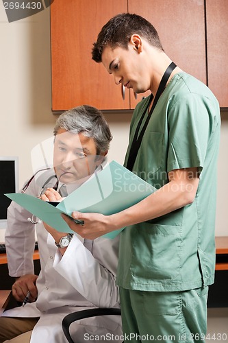 Image of Technician Showing Report To Doctor